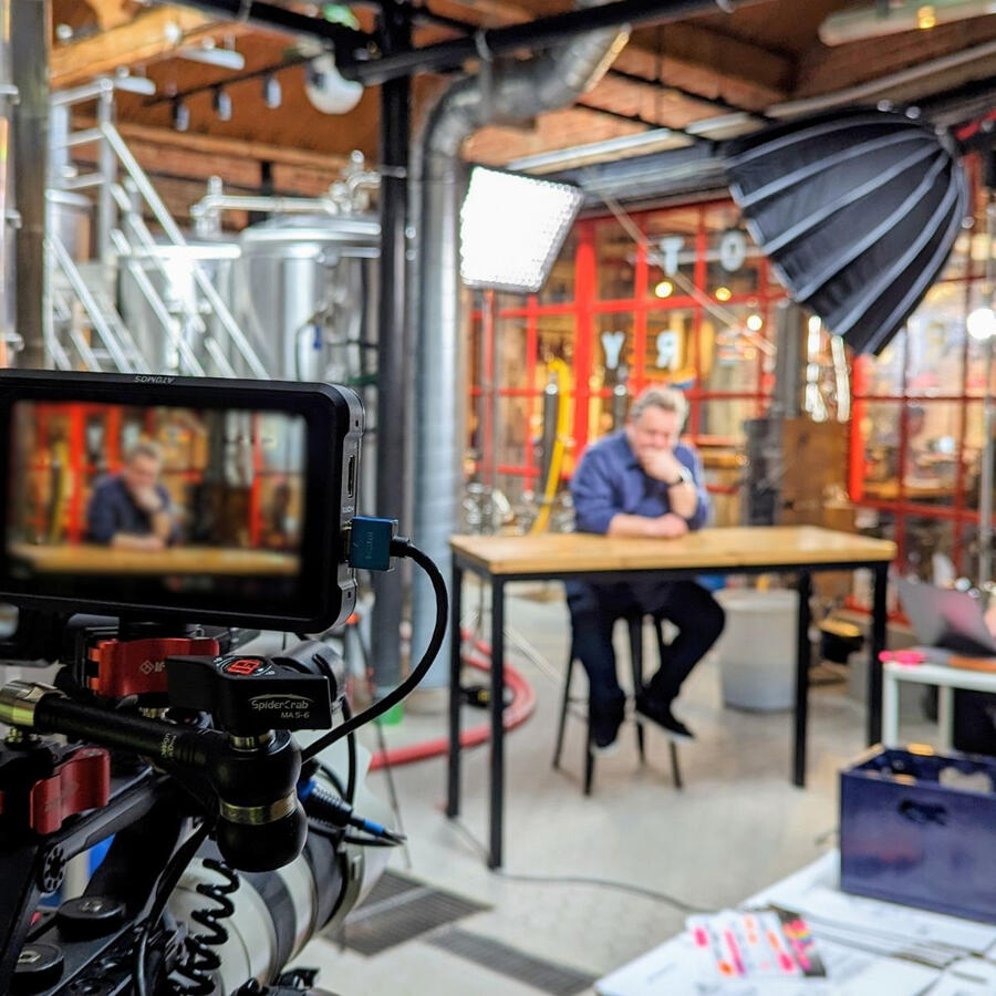 On location, filming an interview Camera monitor and lighting rig set up for a brewery interview